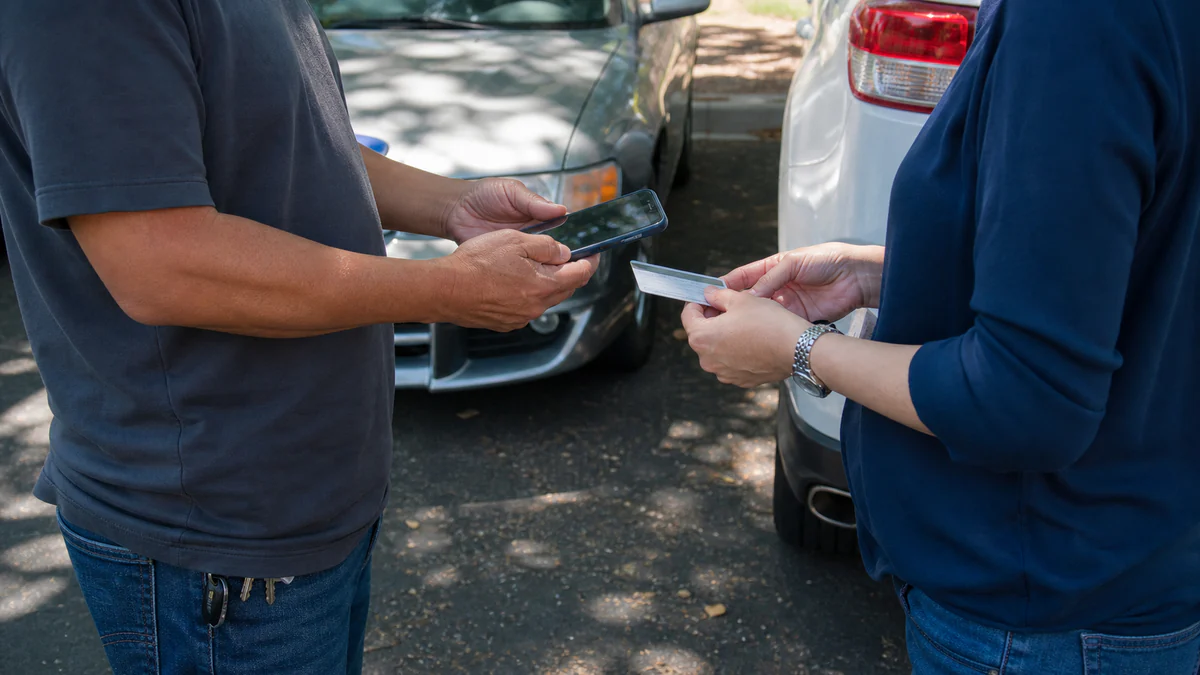 Drivers exchanging insurance information after California accident